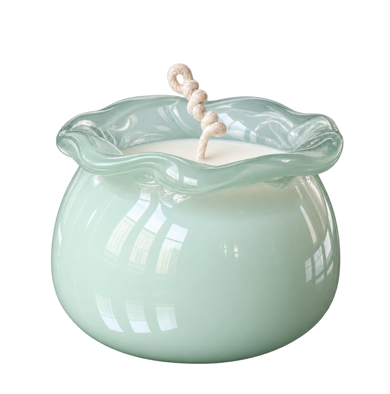 Cardomom candle in a pale green sculptural glass vessel with a knotted wick.